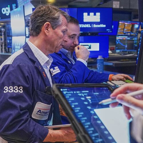 Trader Robert Charmak, left, and Specialist Genarro Saporito work on the floor of the New York Stock Exchange, Wednesday, Feb. 11, 2026. (AP Photo/Richard Drew)