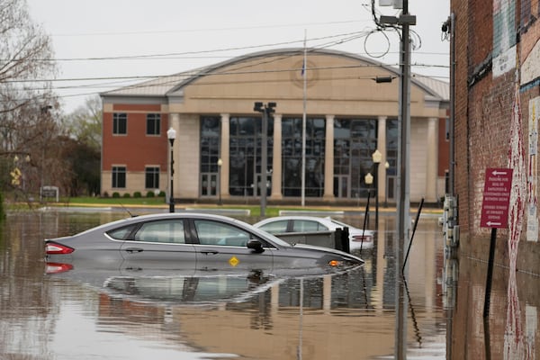Cars sit in a flooded street in Hopkinsville, Ky., Friday, April 4, 2025. (AP Photo/George Walker IV)