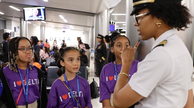 (Left to right) Ron Clark Academy Students Taylor Pough, 10, Valentina Rodin, 10, and Aria Sanders, 10, speak to Delta Airlines pilot Captain Monique Grayson at Hartsfield-Jackson International Airport on Friday, September 22, 2023. The students are a part of Delta’s ‘Women Inspiring our Next Generation’ (WING) program which sponsors an all-female charter flight that carries 100 young women interested in aviation from Atlanta to NASA’s Kennedy Space Center in Florida. (Natrice Miller/ Natrice.miller@ajc.com)