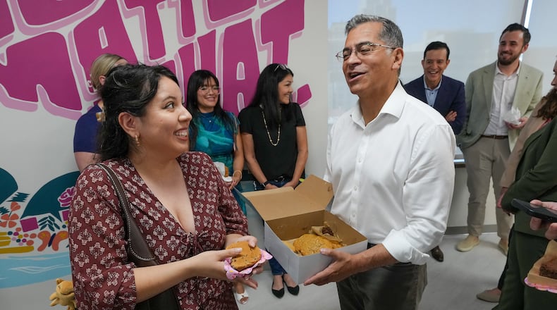 California Democratic gubernatorial candidate Xavier Becerra thanks Amy Perez for her support as he passes out cookies at the Planned Parenthood headquarters in Sacramento, Calif., Monday, June 1, 2026. (AP Photo/Rich Pedroncelli)