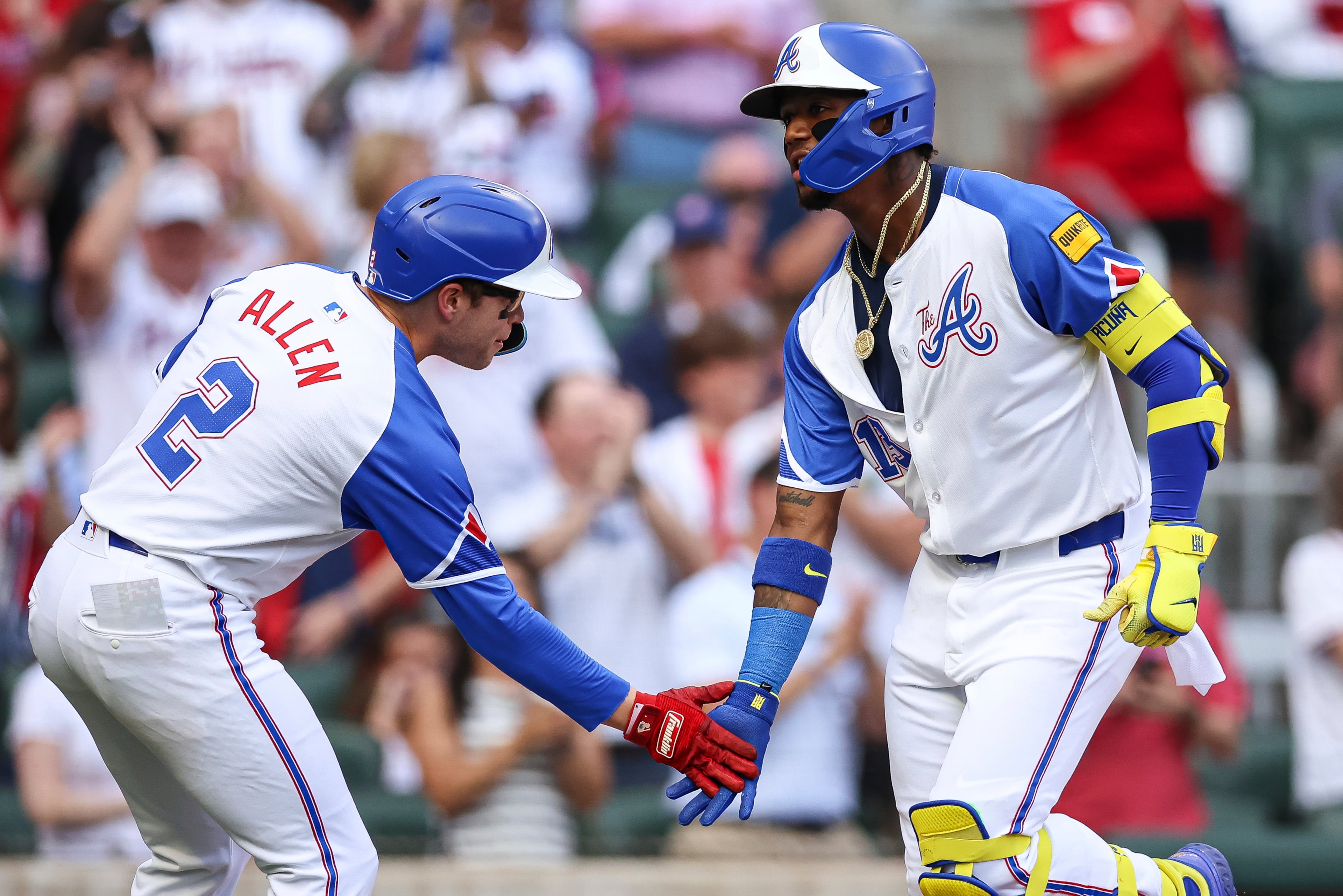 Atlanta Braves' Ronald Acuna Jr., right, low-fives Nick Allen (2) after hitting a two-run home run in the sixth inning of a baseball game against the San Diego Padres, Saturday, May 24, 2025, in Atlanta. (AP Photo/Colin Hubbard)