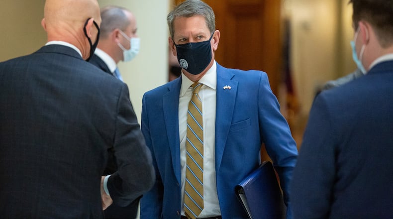 Governor Brian P. Kemp (C) talks with GBI Director Vic Reynolds (L) after a press conference at the State Capital Tuesday, November 24, 2020.  STEVE SCHAEFER / SPECIAL TO THE AJC