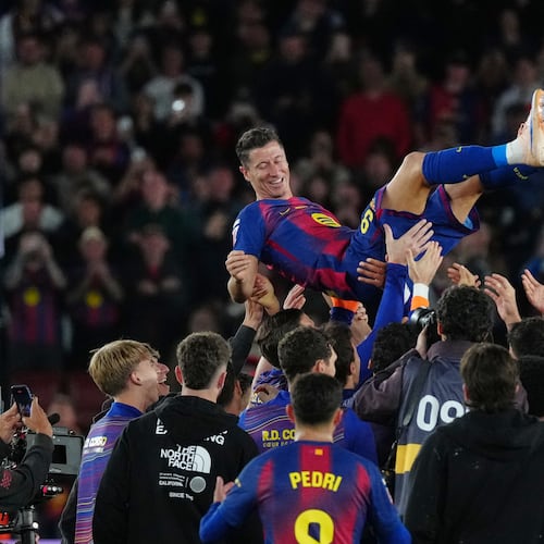 Barcelona's Robert Lewandowski is thrown into the air by his teammates after his last game for the club at the end of the Spanish La Liga soccer match between FC Barcelona and Real Betis in Barcelona, Spain, Sunday, May 17, 2026. (AP Photo/Joan Mateu Parra)