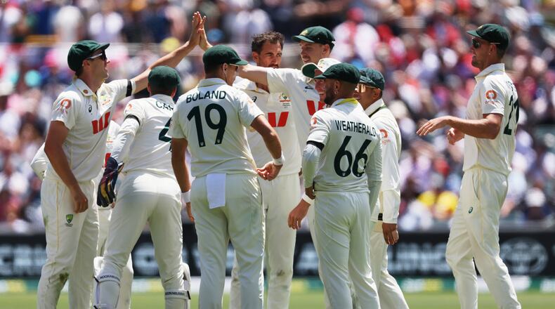 Australian players celebrate the dismissal of England's Jamie Smith during play on the final day of the third Ashes cricket test between England and Australia in Adelaide, Australia, Sunday, Dec. 21, 2025. (AP Photo/James Elsby)