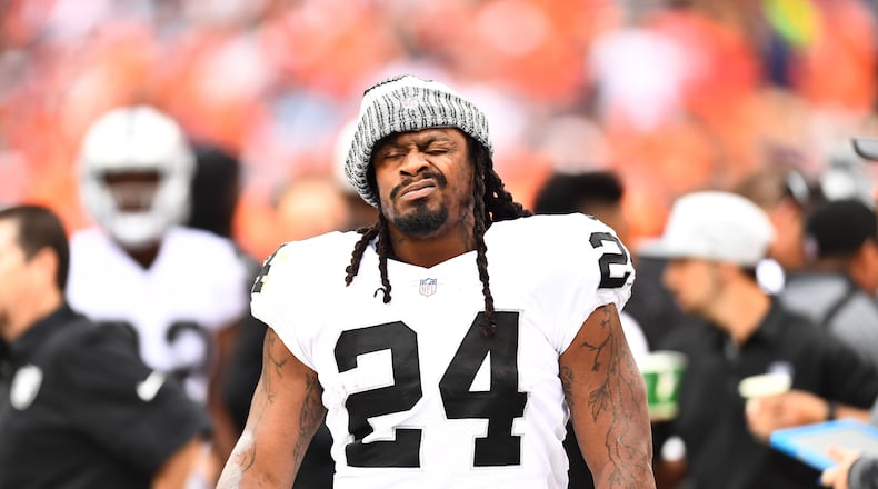 Oakland Raiders running back Marshawn Lynch (24) walks the sidelines during the third quarter against the Denver Broncos at Sports Authority Field at Mile High.