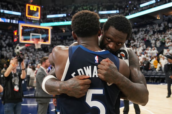 Minnesota Timberwolves forward Julius Randle (30) and Minnesota Timberwolves guard Anthony Edwards (5) hug after Game 5 of an NBA basketball second-round playoff series against the Golden State Warriors, Thursday, May 15, 2025, in Minneapolis. (AP Photo/Abbie Parr)
