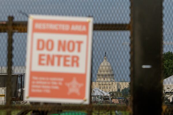 The U.S. Capitol is seen through security fencing, set up on the National Mall, during preparations for an upcoming military parade commemorating the Army's 250th anniversary and coinciding with President Donald Trump's 79th birthday, Thursday, June 12, 2025, in Washington. (AP Photo/Rod Lamkey, Jr.)
