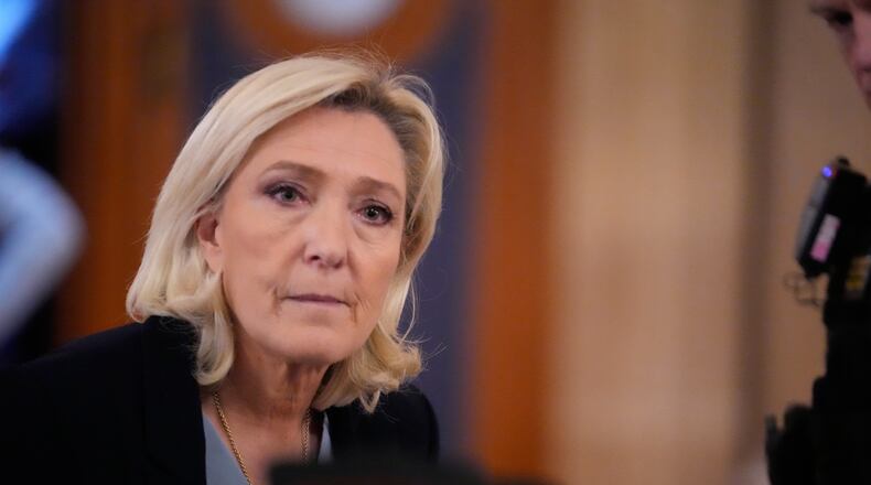 FILE - Far-right leader Marine Le Pen walks outside the courtroom during a short break in her appeals trial in Paris, on Jan. 20, 2026. (AP Photo/Michel Euler, File)