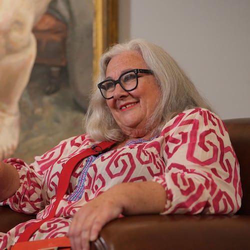 Sue Tilley, a model for British painter Lucian Freud, speaks in front of Freud's painting of her, titled "Sleeping by the Lion Carpet" during an interview in Sotheby's auction house in London, Thursday, May 28, 2026. (AP Photo/Kin Cheung)