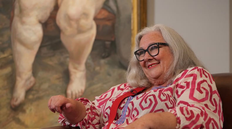 Sue Tilley, a model for British painter Lucian Freud, speaks in front of Freud's painting of her, titled "Sleeping by the Lion Carpet" during an interview in Sotheby's auction house in London, Thursday, May 28, 2026. (AP Photo/Kin Cheung)