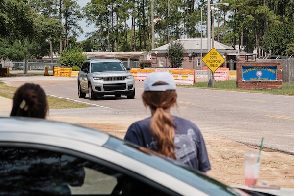 Kelsey Heath, left, and Emma Touchstone, 17, wait for reality television star Todd Chrisley to walk out of the Federal Prison Camp, Wednesday, May 28, 2025, in Pensacola, Fla. (AP Photo/Dan Anderson)