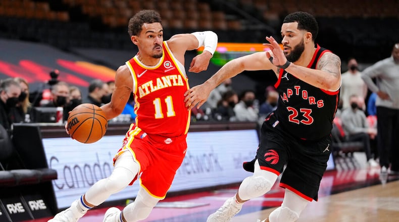 Atlanta Hawks guard Trae Young (11) drives around Toronto Raptors guard Fred VanVleet (23) during the second half of an NBA basketball game Friday, Feb. 4, 2022, in Toronto. (Frank Gunn/The Canadian Press via AP)