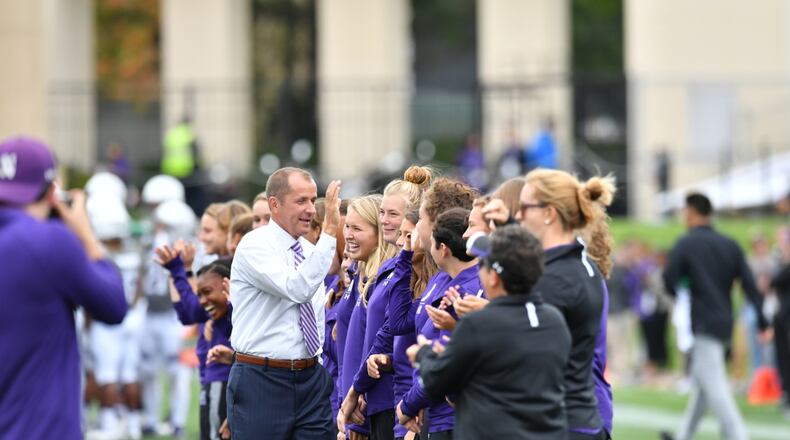 Jim Phillips high-fives members of the Northwestern field-hockey team at a Wildcats football game in 2019 in Evanston, Ill., in his capacity as the school's athletic director. Phillips was named commissioner of the ACC in December 2020. (Northwestern Athletics)
