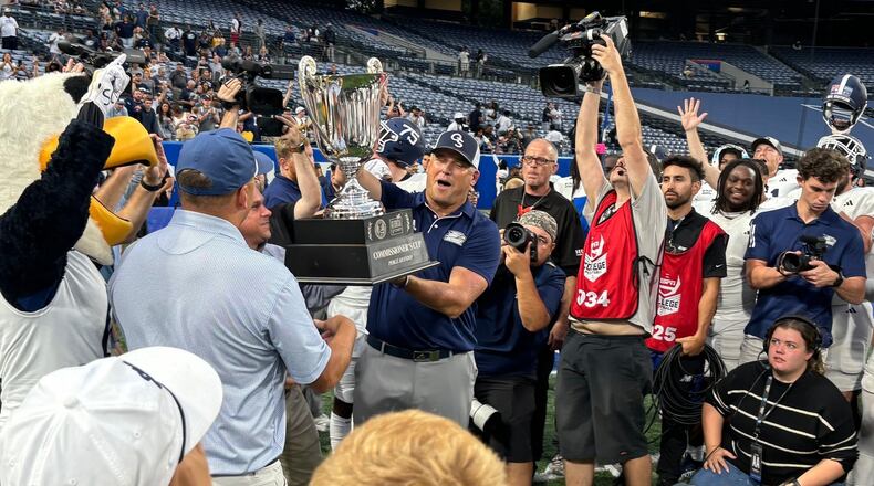 Georgia Southern coach Clay Helton holds the Commissioners Cup after beating Georgia State38-21 at Center Parc Stadium in Atlanta, Sept. 28, 2024. (Photo by Stan Awtrey)