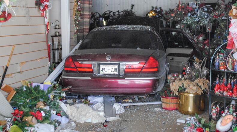 This Monday, Dec. 1, 2014 photo shows Rep. Judd Matheny's car after it crashed into Martha's Flower and Gifts in Tullahoma, Tenn. Matheny said his dog had jumped into the front seat of his 2005 Mercury and that the lawmaker tried to hit the brake pedal but mistakenly slammed on the gas. (AP Photo/Tullahoma News, Wayne Thomas)
