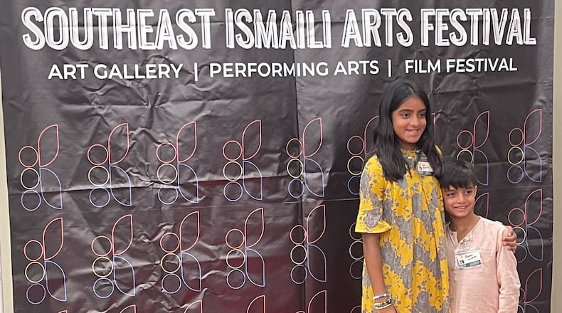 Sufi Momin, 12, poses with her brother Rumi at a Southeast Ismaili Arts Festival event. Sufi created a short documentary about biodiversity and climate change that will be screened Sept. 16 at the festival held at the Rialto Center for Performing Arts at Georgia State University. (Courtesy of Behnoosh Momin)