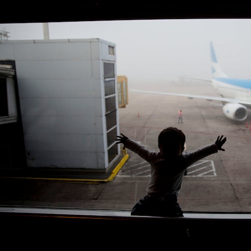 FILE - A child watches a plane at the Jorge Newbery airport in Buenos Aires, Argentina, April 14, 2016. (AP Photo/Natacha Pisarenko, File)