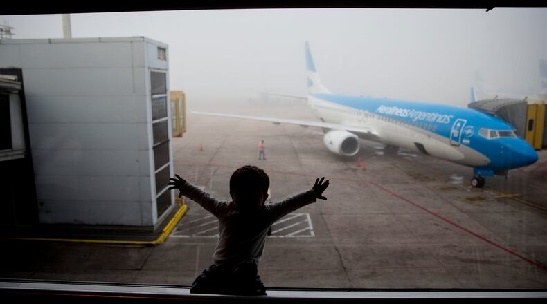 FILE - A child watches a plane at the Jorge Newbery airport in Buenos Aires, Argentina, April 14, 2016. (AP Photo/Natacha Pisarenko, File)