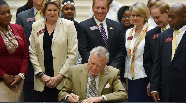 April 21, 2015 Atlanta - Gov. Nathan Deal signs House Bill 372, his plan to allow the state takeover of Georgia’s “failing” schools, at The Georgia State Capitol in Atlanta on Tuesday, April 21, 2015. HYOSUB SHIN/AJC
