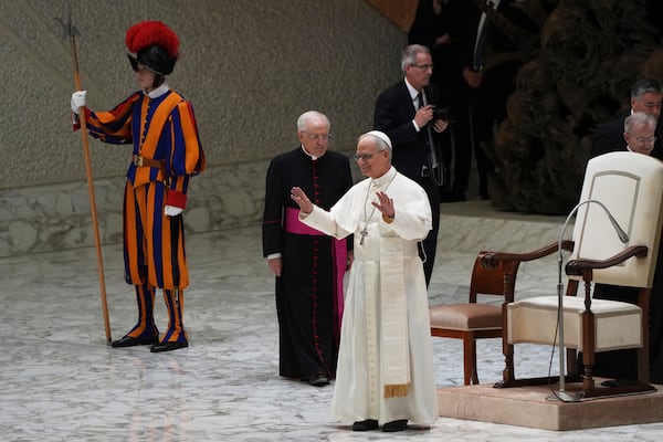 Pope Leo XIV arrives as he meets members of the international media in the Paul VI Hall at the Vatican, Tuesday, May 13, 2025. (AP Photo/Domenico Stinellis)