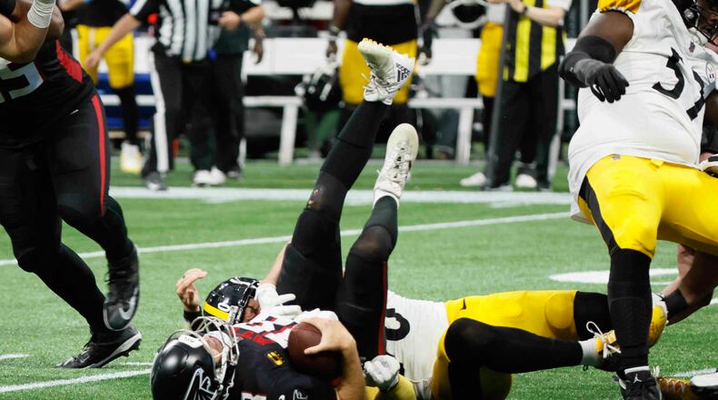Atlanta Falcons quarterback Kirk Cousins (18) lays on the ground after being sacked in the last play of the game on Sunday, Sept. 8, at Mercedes-Benz Stadium in Atlanta. The Falcons lost 18-10.
(Miguel Martinez/ AJC)