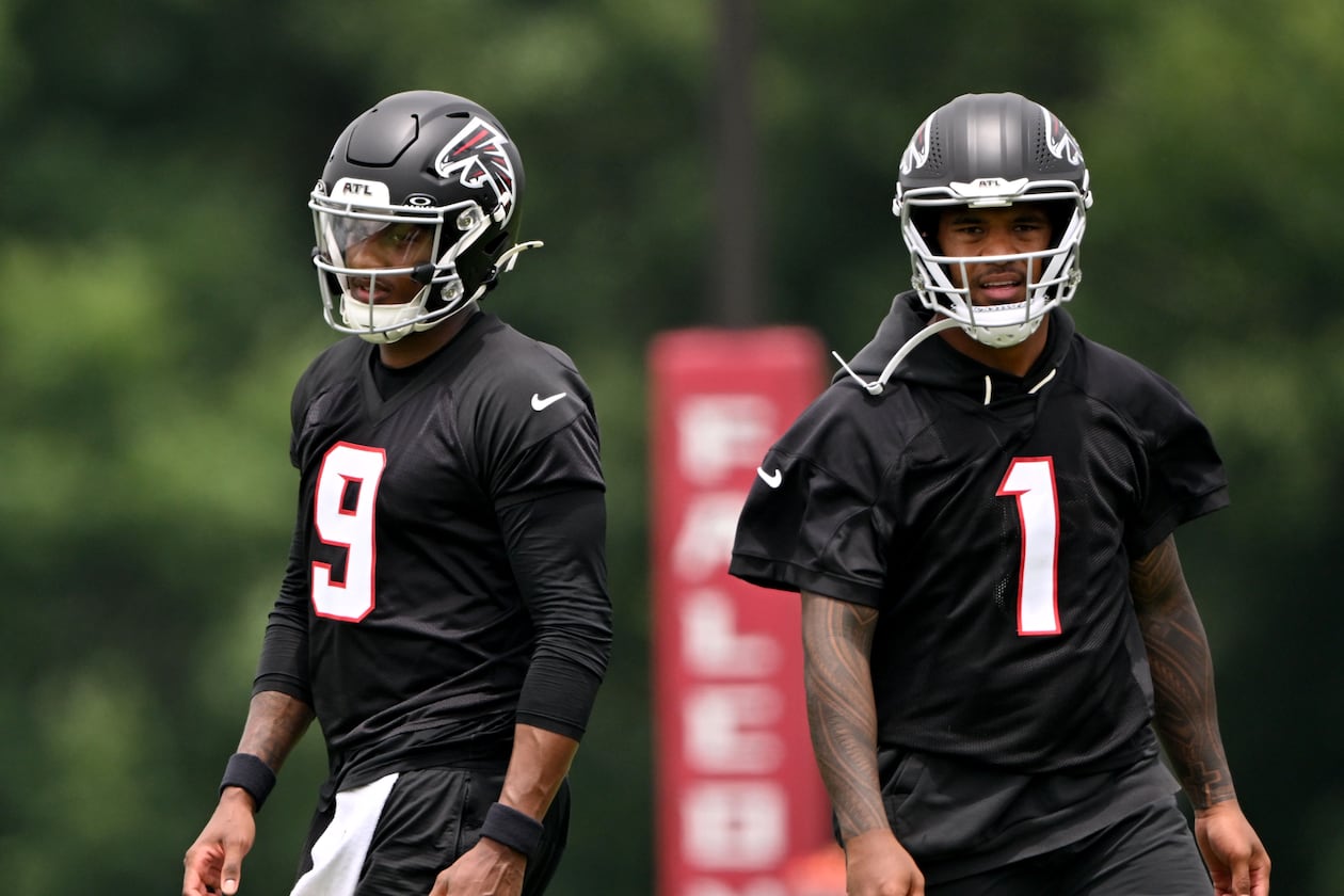 Falcons quarterbacks Michael Penix Jr. (left) and Tua Tagovailoa run drills during an OTA workout at the team's training facility Wednesday, May 27, 2026, in Flowery Branch. (Hyosub Shin/AJC)