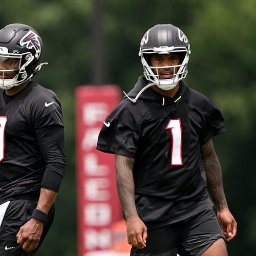 Falcons quarterbacks Michael Penix Jr. (left) and Tua Tagovailoa run drills during an OTA workout at the team's training facility Wednesday, May 27, 2026, in Flowery Branch. (Hyosub Shin/AJC)