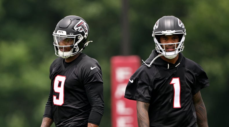 Falcons quarterbacks Michael Penix Jr. (left) and Tua Tagovailoa run drills during an OTA workout at the team's training facility Wednesday, May 27, 2026, in Flowery Branch. (Hyosub Shin/AJC)