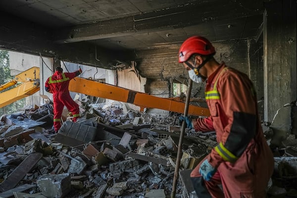 In this photo taken Tuesday, June 24, 2025, rescuers search through the rubble of a damaged section of Evin Prison following an Israeli strike the day before, in Tehran, Iran. (AP Photo/Mostafa Roudaki/Mizan News Agency)