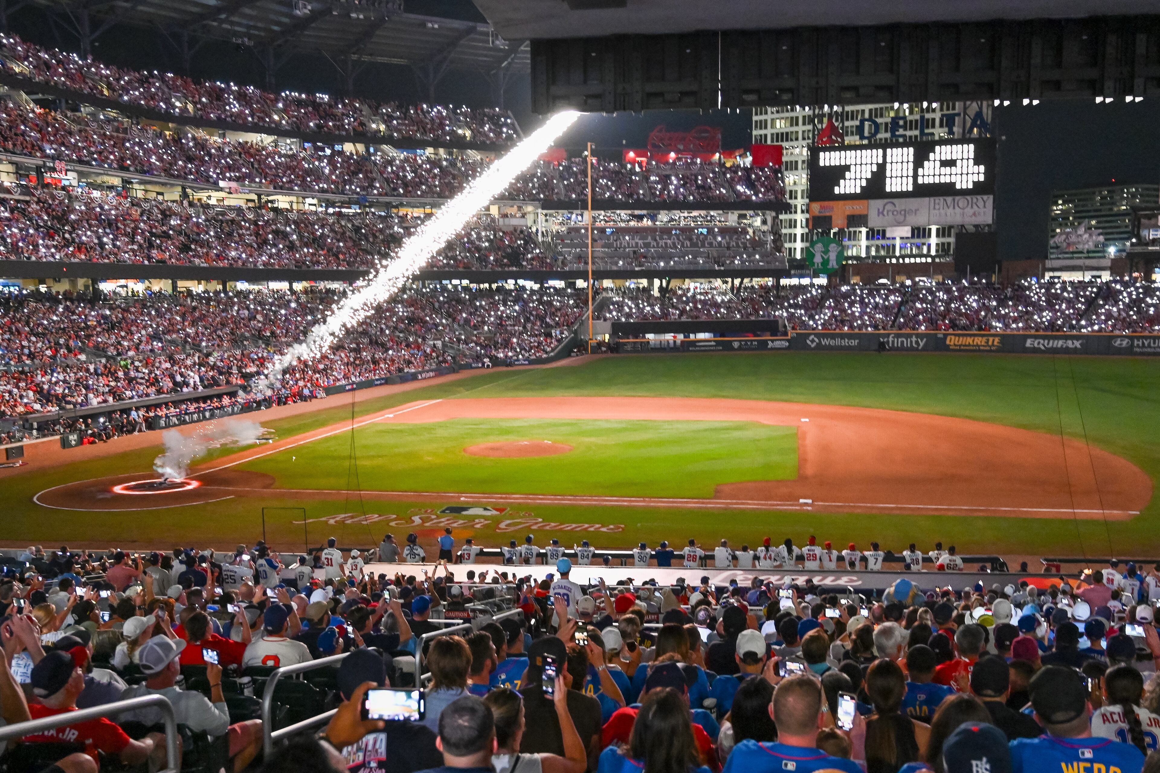 A firework simulating the path of Hank Aaron's record-breaking 715th home run streaks above the field at Truist Park.