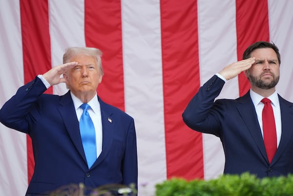 President Donald Trump and Vice President JD Vance salute as they attend the 157th National Memorial Day Observance at Arlington National Cemetery, Monday, May 26, 2025, in Arlington, Va. (AP Photo/Jacquelyn Martin)