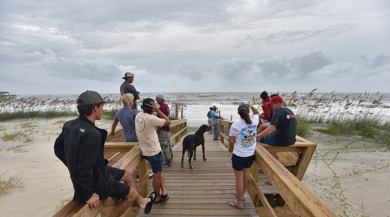 September 4, 2019 Tybee Island - Local residents and beachgoers who decided to stay watch the waves caused by Hurricane Dorian in Tybee Island on Wednesday, September 4, 2019. Gov. Brian Kemp on Wednesday expanded a state of emergency to include nine additional counties as Hurricane Dorianâs outer rain bands reached the Georgia coast. (Hyosub Shin / Hyosub.Shin@ajc.com)