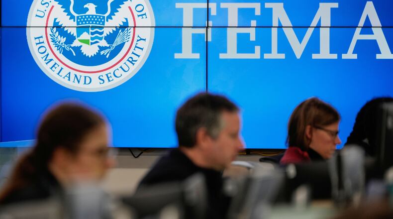FILE - People work at the Federal Emergency Management Agency headquarters in Washington, Jan. 24, 2026. (AP Photo/Julia Demaree Nikhinson, File)