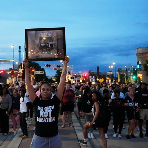A protester holds a photo of Corey Durell Ruiz as they march Thursday, July 23, 2026, in Madison, Wis., after he was shot and killed by a Madison police officer on Wednesday. (AP Photo/Kayla Wolf)