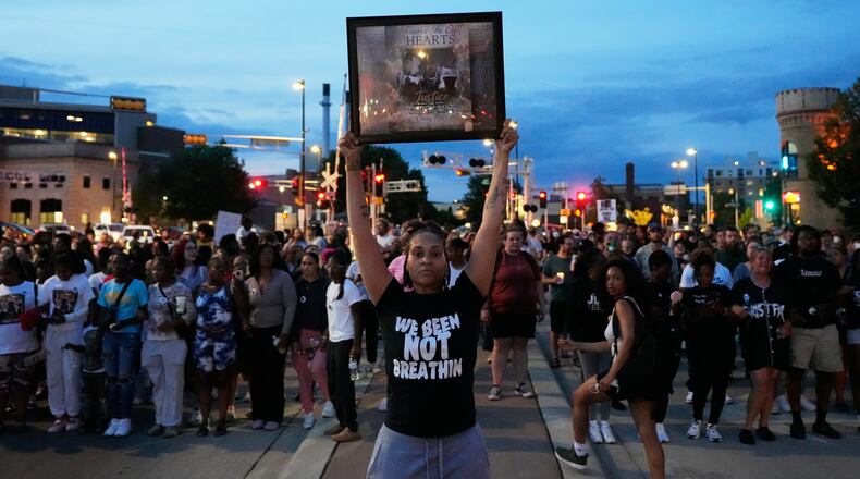 A protester holds a photo of Corey Durell Ruiz as they march Thursday, July 23, 2026, in Madison, Wis., after he was shot and killed by a Madison police officer on Wednesday. (AP Photo/Kayla Wolf)
