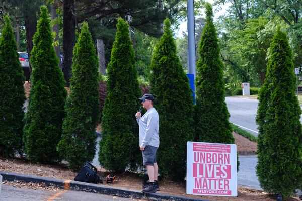 Jason Cantrell, an anti-abortion activist, speaks through a loudspeaker to somebody at Feminist Women’s Health Center in Atlanta on May 3, 2022.  Of the Supreme Court’s leaked draft opinion to overturn Roe v. Wade, Cantrell tells the AJC, “Who knows what’s going to happen. Even if Roe was overturned… it’d go back to the states, so it’d be up to each individual state to decide whether they wanted abortion to be legal. It wouldn’t just totally make it illegal. So I’m ‘wait and see.’”