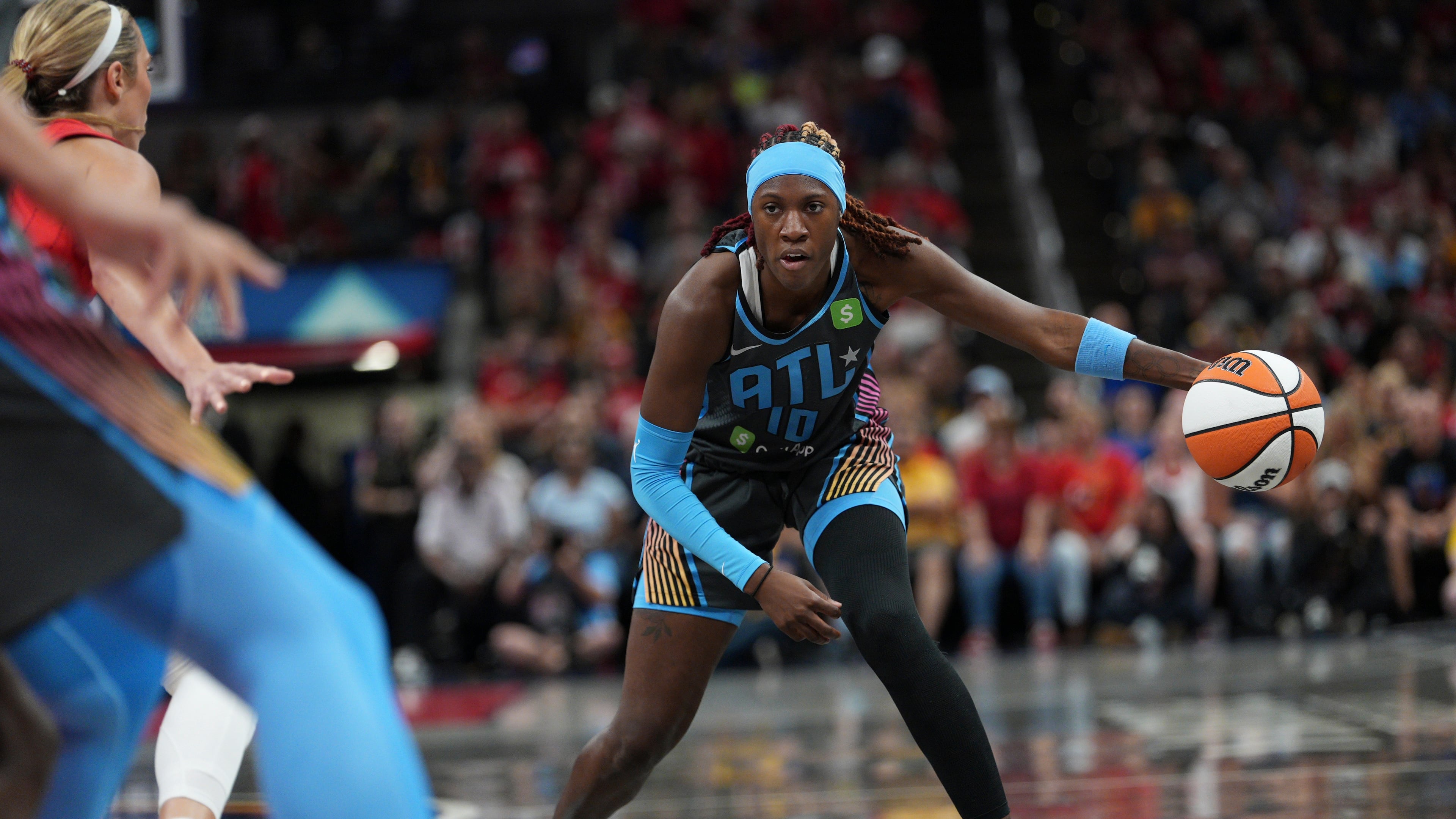 Atlanta Dream's Rhyne Howard (10) dribbles during the first half of a WNBA basketball game against the Indiana Fever, Friday, July 11, 2025, in Indianapolis. (AP Photo/AJ Mast)