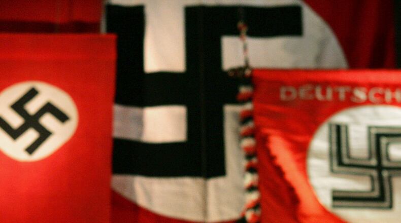 A Nazi flag, reportedly hung for a history lesson, remained in the window of a public school classroom over the weekend. Many took to Facebook to express their outrage and confusion.