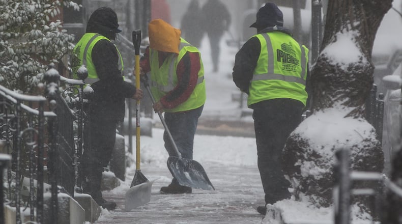 BOSTON, MA - FEBRUARY 09: A cleaning crew works to remove snow in the Beacon Hill neighborhood as a winter storm strengthens on February 9, 2017 in Boston, Massachusetts. A local meteorologist was reporting on the storm when her shot was crashed by man in costume covered in marijuana leaves. (Photo by Scott Eisen/Getty Images)