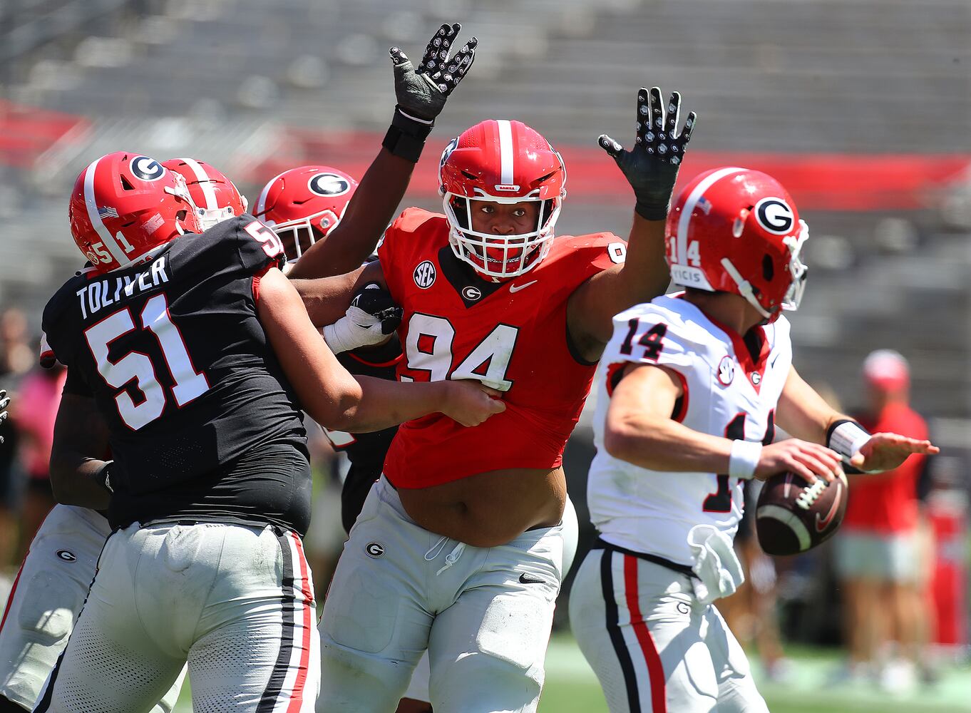 Defensive lineman Xzavier McLeod comes with the pressure against quarterback Gunner Stockton during the G-Day game on Saturday, April 13, 2024.  Curtis Compton for the Atlanta Journal Constitution