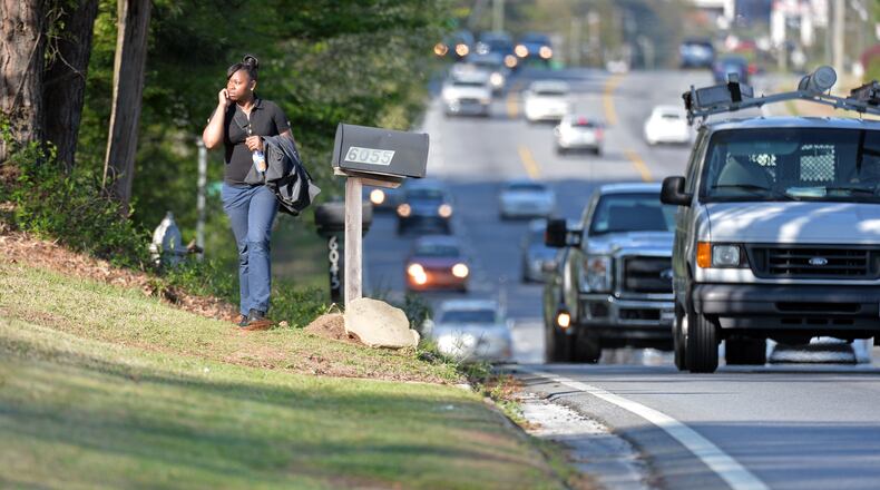 Alberta Watson walks along Lawrenceville Highway in Gwinnett County on April 9, 2014, one of several roads that could get sidewalks in the latest round of 2014 SPLOST funding. HYOSUB SHIN / HSHIN@AJC.COM