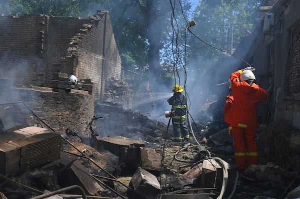 Emergency services personnel work to extinguish a fire following a Russian attack in Odesa, Ukraine, Friday, July 11, 2025. (AP Photo/Michael Shtekel)