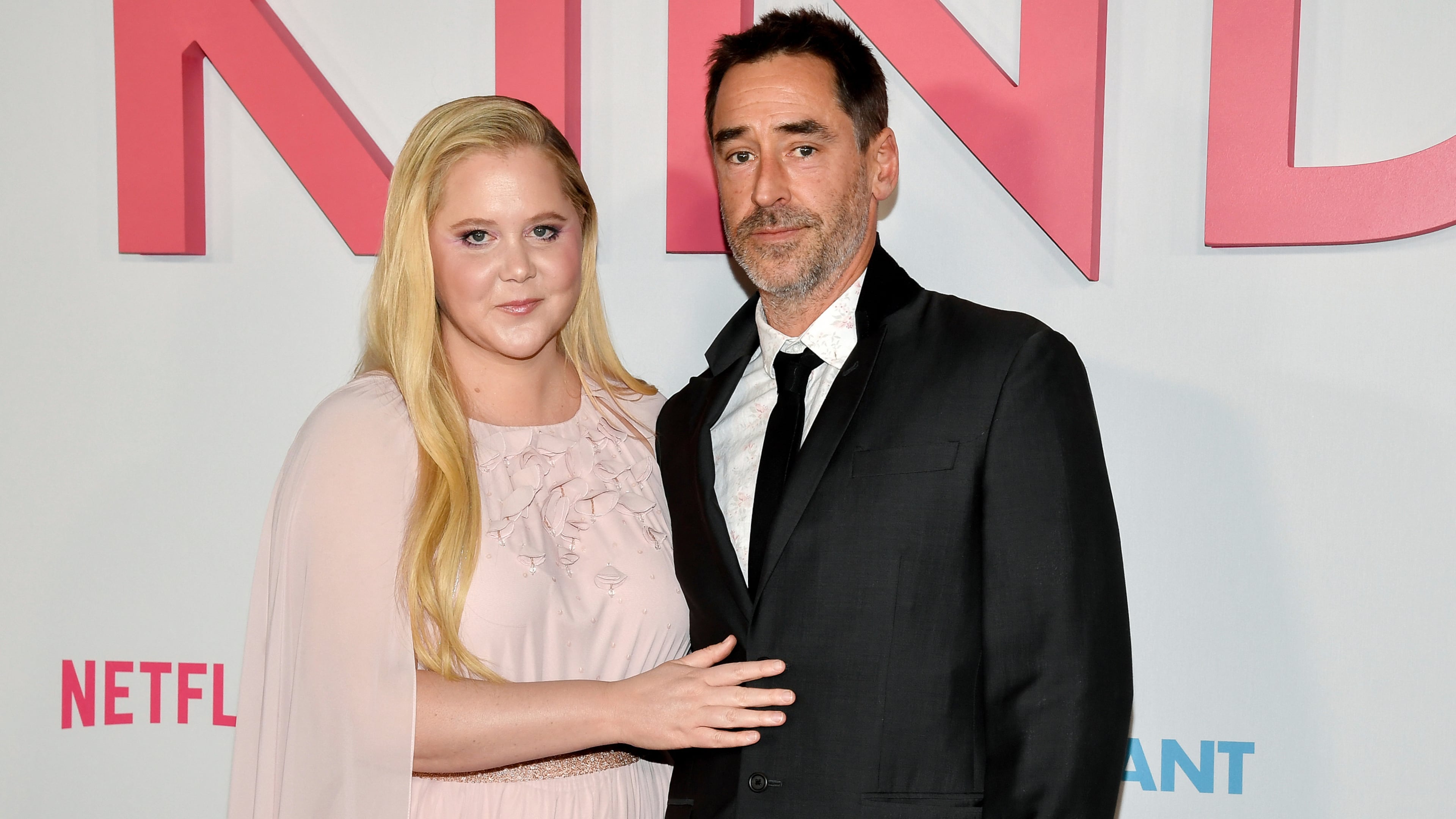 FILE - Amy Schumer and husband Chris Fischer attend the premiere of Netflix's "Kinda Pregnant" at The Plaza Hotel in New York, Feb. 3, 2025. (Photo by Evan Agostini/Invision/AP File)