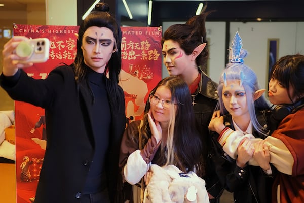 This photo provided by Chang Liu shows audience members dressed in cosplay taking a selfie at a screening of the movie Ne Zha 2 in New York on March 1. (Chang Liu via AP)