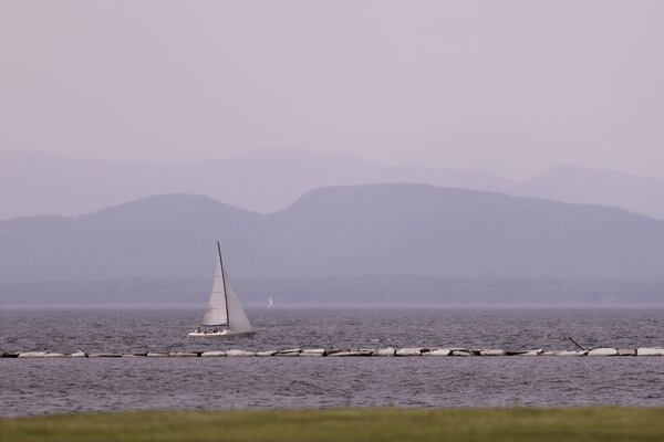 Hazy skies due to smoke from wildfires in Canada are seen over Lake Champlain and the Adirondack Mountains on Wednesday, June 4, 2025, in Burlington, Vt. (AP Photo/Amanda Swinhart)