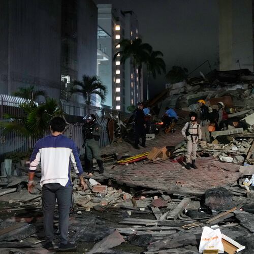 People walk amid debris after an earthquake in Caracas, Venezuela, Wednesday, June 24, 2026. (AP Photo/Ariana Cubillos)