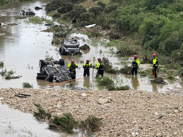 Authorities respond after vehicles were swept away by floodwaters in San Antonio, Tx., on Thursday, June 12, 2025. (AP Photo/Lekan Oyekanmi)