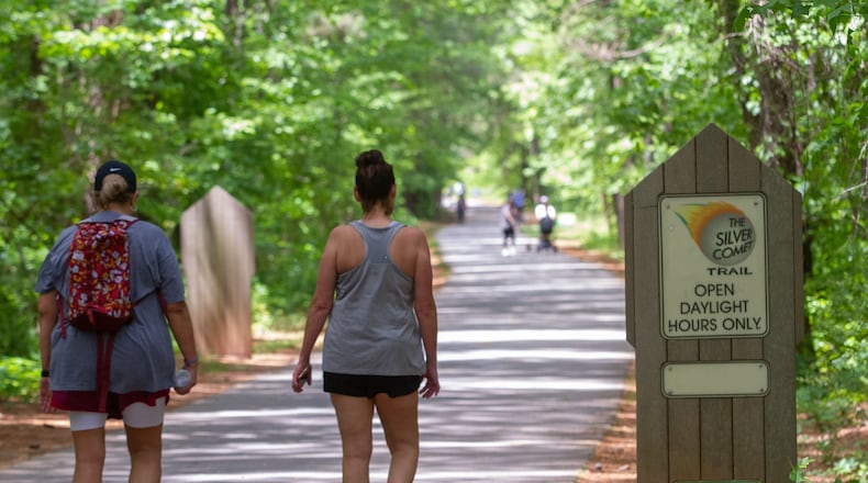 People walk along the Silver Comet Trail in Smyrna on Saturday. STEVE SCHAEFER / SPECIAL TO THE AJC