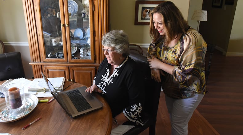 Maureen Miles calls her brother Chris Miles via Skype, as her daughter Margaret Councilman looks on, at Miles' home in Fayetteville. Maureen Miles, 72, of Fayetteville spent years looking for a connection to the father she never knew.
