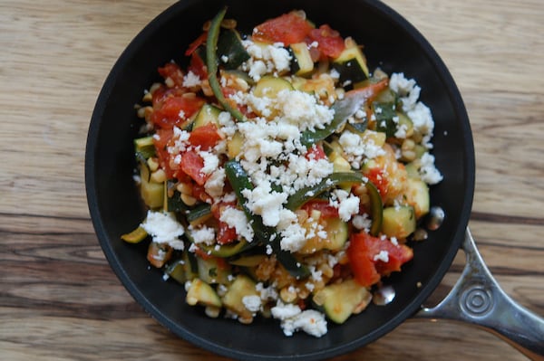 This Mexican-inspired dish highlights fresh corn, zucchini and tomatoes. (Meridith Ford for the AJC)